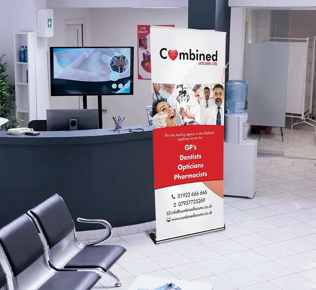 A pull-up roller banner stand displayed beside printed PVC banners